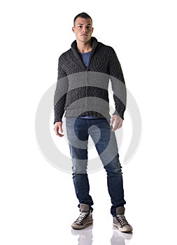 Full body shot of attractive young man with wool sweater and jeans