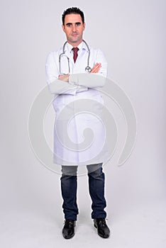 Full body shot of handsome man doctor against white background