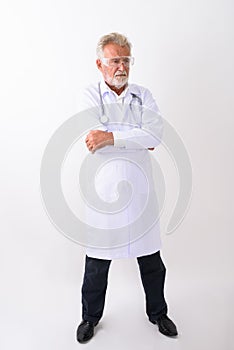 Full body shot of handsome senior bearded man doctor standing wh