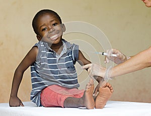 Full body shot of a happy African black child getting a needle injection as a medical vaccination