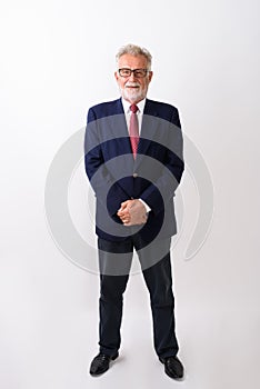 Full body shot of happy senior bearded businessman smiling and s