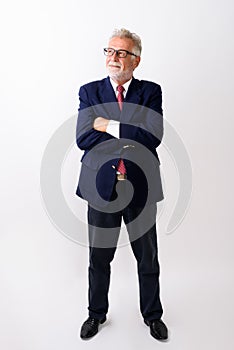 Full body shot of happy senior bearded businessman smiling and s