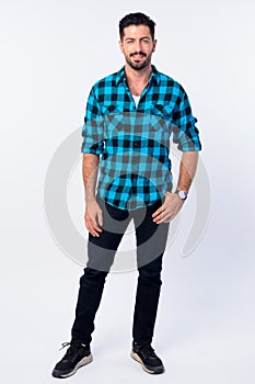 Full body shot of young handsome bearded hipster man