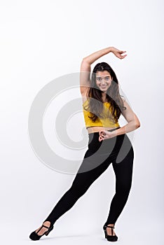 Full body shot of young happy Indian woman smiling while posing