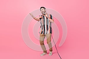 Full body size photo of professional singer brunet hair man loves music karaoke meloman dedicates song  on pink photo