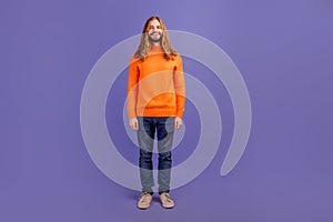 Full body size photo of young handsome blond long hair man wearing orange sweater happy hipster isolated on violet color