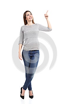 Full body of a standing casual woman pointing at side photo