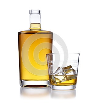 A full bottle of golden whisky, with no label or branding, and a glass of whisky and ice, isolated on white