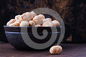 Full bowl of hazelnuts on table