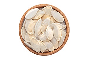Full bowl of pumpkin seeds isolated on a white background. File contains clipping path