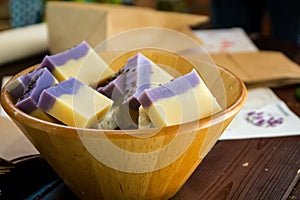 A full bowl of soap is made from lavender flowers.