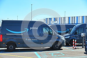 Full electric delivery vans parked at amazon e-commerce  company logistic hub