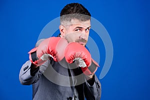 Full of energy. bearded man in boxing gloves punching. Business and sport success. powerful man boxer ready for