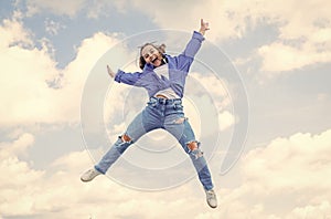 full of energy. childhood happiness. teen girl jumping high in the sky. having a party fun. Autumn style. Happy kid wear