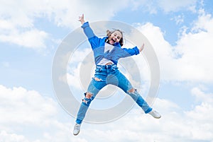 full of energy. childhood happiness. teen girl jumping high in the sky. having a party fun. Autumn style. Happy kid wear