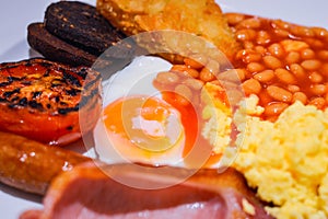 Full English Breakfast with Bacon, Sausage, Fried Egg, Beans, Scrambled Eggs, Hash Browns and Black Pudding.