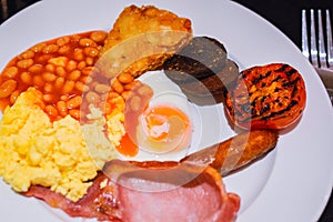 Full English Breakfast with Bacon, Sausage, Fried Egg, Beans, Scrambled Eggs, Hash Browns and Black Pudding.