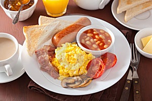 Full english breakfast with scrambled eggs, bacon, sausage, bean