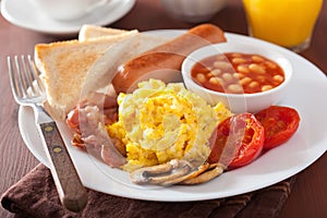 Full english breakfast with scrambled eggs, bacon, sausage, bean