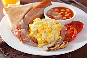 Full english breakfast with scrambled eggs, bacon, sausage, bean