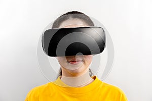 Full-face close-up portrait of a young woman wearing virtual reality glasses. White background. The concept of virtual reality and