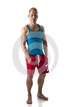 Full figure of muscular, young man standing confident barefeet, smiling photo