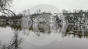 Full-flowing river in gloomy weather, after the spring ice drift.