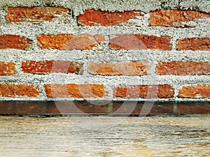 Old Grungy Grainy Wooden Table Top Against Bare Brick Wall