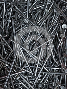 Full frame background showing lots of metallic nails. Close up of carpentry shiny nails background