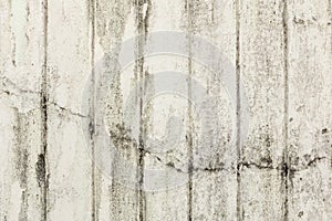 Full frame background of weathered, faded and dirty concrete wall with plaster peeled off for background