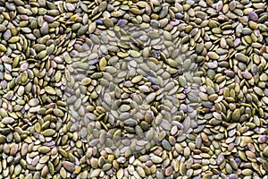 Full frame close-up raw pumpkin seeds pepitas in flat lay format