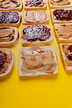 Full frame close-up shot of bread slices with preserves and peanut butter arranged alternatively