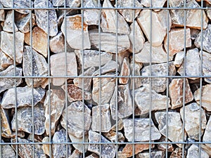 Metal grid with stones on the wall