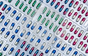 Full frame of colorful antimicrobial capsule pills. Quality control error in pharmaceutical manufacturing. photo