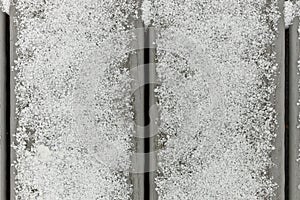 Full Frame Flatlay of A Thin Fresh Layer of Graupel Snow on Gray Deck Boards