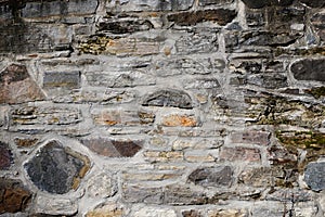 Full frame of an old stonewall built in the 18th century from the historical site of the old forges of Quebec St-Maurice river
