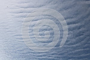 Full frame of pretty blue sky with unusual scudding cloud formation