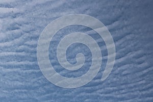 Full frame of pretty blue sky with unusual scudding cloud formation