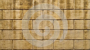Full frame shot of an old textured wall with rectangular blocks.