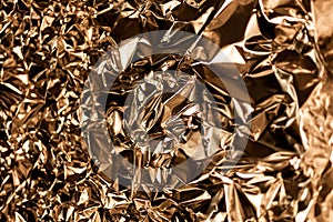 Full frame take of a sheeT of crumpled gold aluminum foil