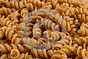 Full frame of wholegrain spiral pasta. Selective focus