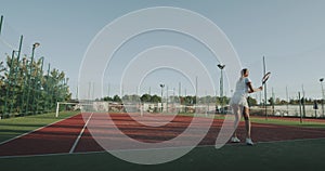 Full game of tennis outside on the tennis court , two sportiv women playing professional.