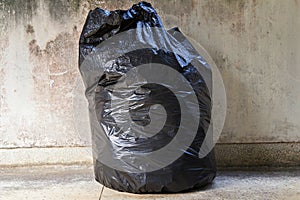 Full garbage bag on floor