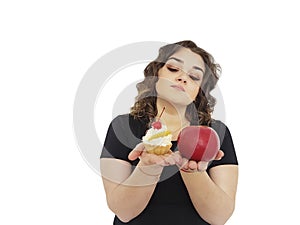 Full girl choosing dieting cake and an apple isolated dilemma resist