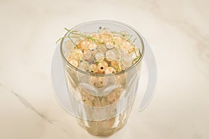 full glass of currant on a marble background/full glass of currant on a marble background, selective focus