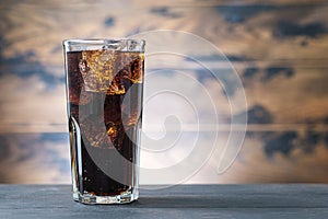 Full glass drink cola with ice cubes. Soda with bubbles