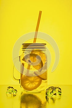 Full glass of fresh cool transparent water with lemon and ice