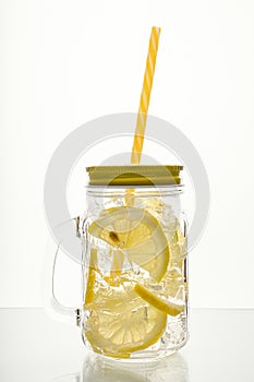 Full glass of fresh cool transparent water with lemon and ice