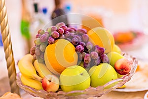 Full glass vase of ripe tasty fruit