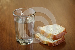 Full glass of water and two slices of bread